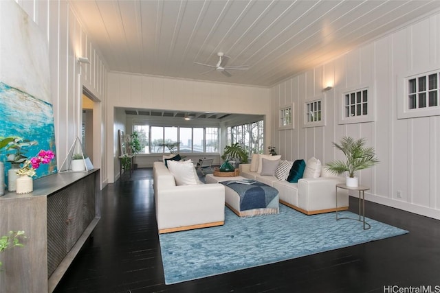 living room with ceiling fan and dark hardwood / wood-style floors