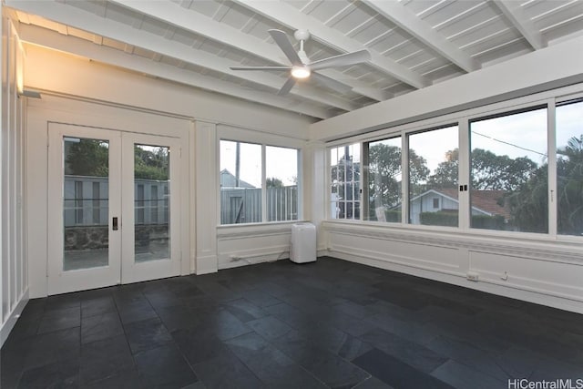 unfurnished sunroom featuring ceiling fan, beam ceiling, and french doors