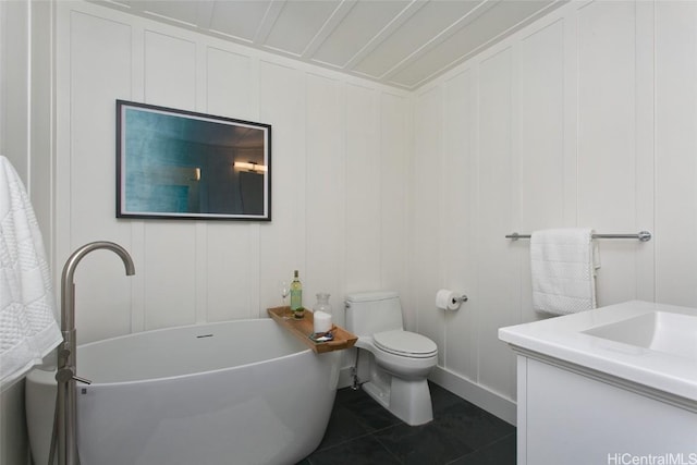 bathroom with toilet, vanity, tile patterned floors, and a bathtub