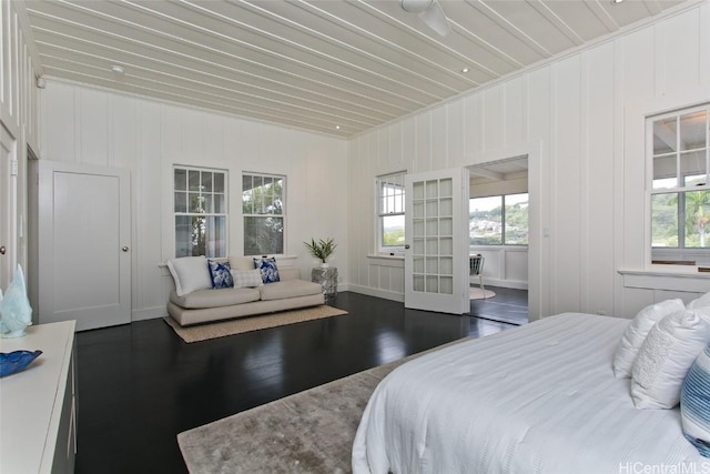 bedroom with dark hardwood / wood-style flooring, wood ceiling, and french doors