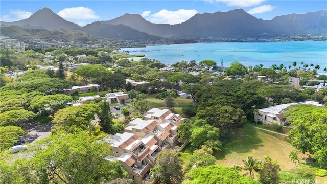 birds eye view of property with a water and mountain view