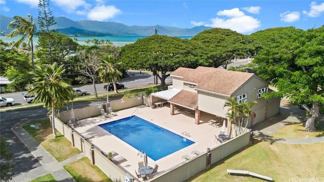 view of pool with a patio area and a water and mountain view