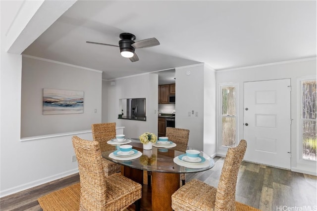 dining room featuring crown molding, ceiling fan, and dark wood-type flooring