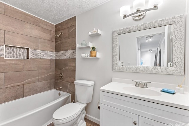 full bathroom featuring a textured ceiling, vanity, toilet, and tiled shower / bath