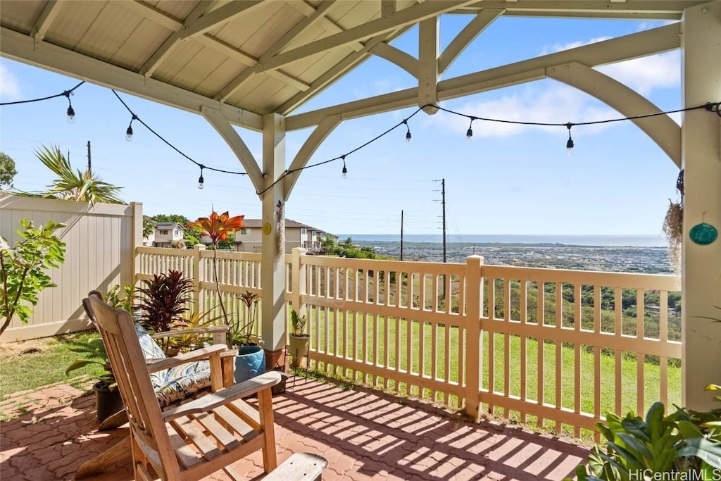 wooden terrace with a yard and a water view