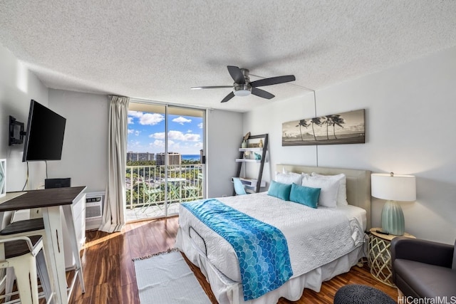 bedroom featuring a textured ceiling, access to outside, ceiling fan, and hardwood / wood-style flooring