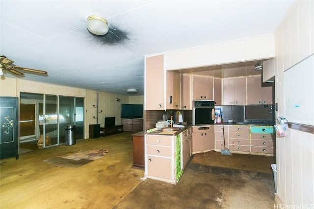 kitchen featuring oven and ceiling fan