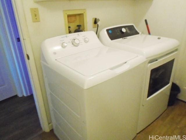 washroom with dark hardwood / wood-style floors and washer and clothes dryer