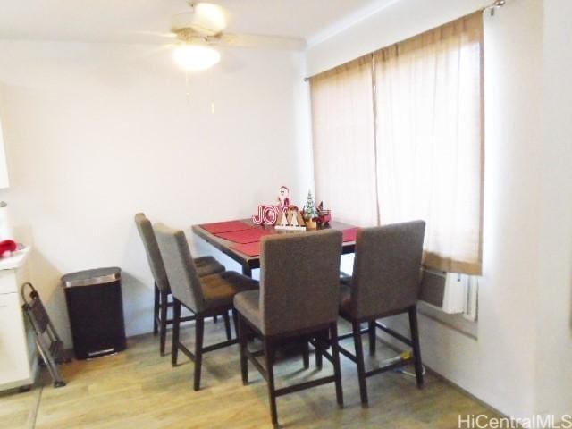 dining room with wood-type flooring and ceiling fan