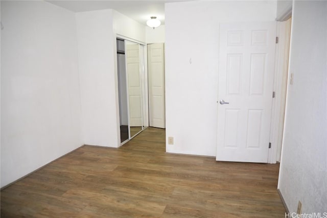 unfurnished bedroom featuring a closet and wood finished floors