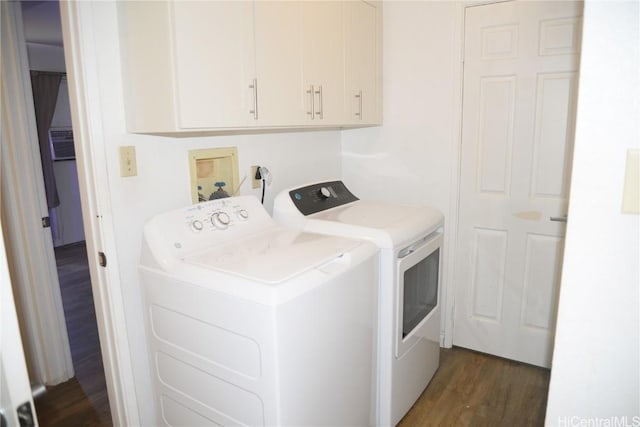 laundry area featuring dark wood finished floors, cabinet space, and independent washer and dryer