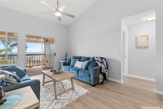 living room featuring light hardwood / wood-style flooring, ceiling fan, and lofted ceiling