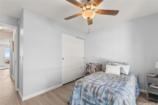 bedroom with a closet, ceiling fan, and light hardwood / wood-style flooring