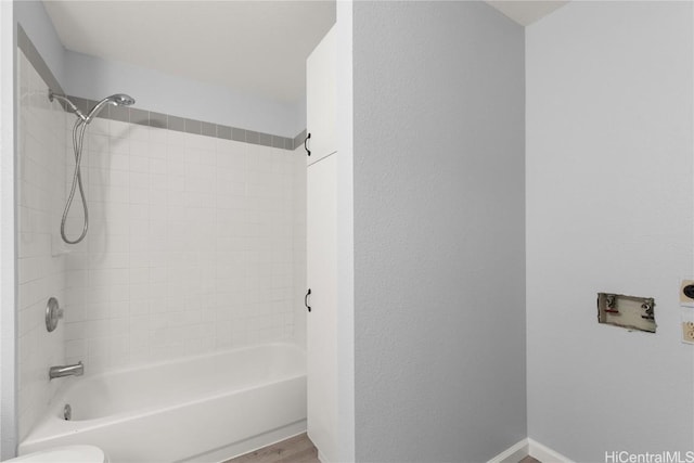 bathroom featuring wood-type flooring and tiled shower / bath combo