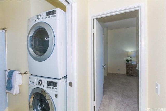 laundry room with stacked washer / dryer and light colored carpet