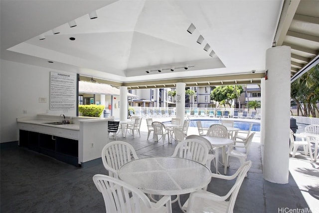 view of patio / terrace featuring sink and a community pool