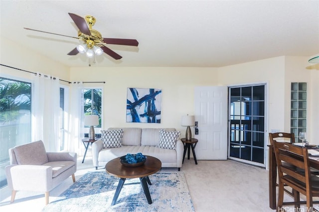 living room featuring ceiling fan and light carpet