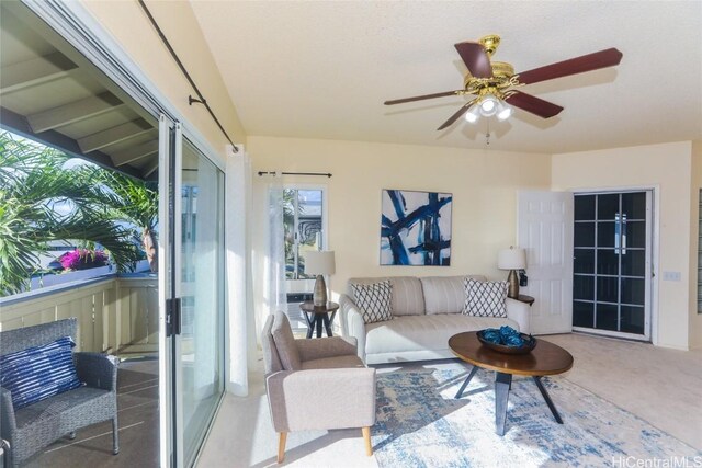 carpeted living room featuring ceiling fan