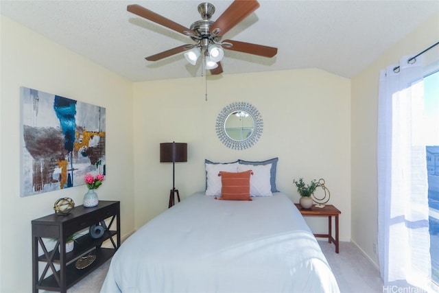 bedroom with carpet, ceiling fan, a textured ceiling, and vaulted ceiling