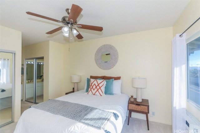 carpeted bedroom featuring connected bathroom and ceiling fan