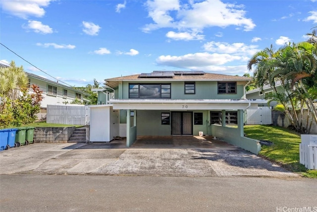 view of front of house featuring a carport and solar panels