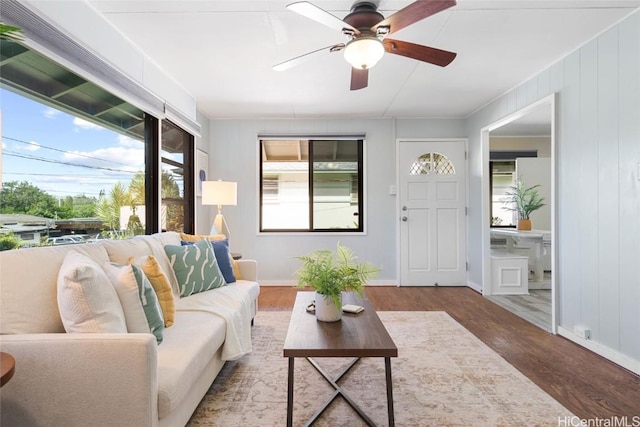 living room featuring hardwood / wood-style floors and ceiling fan