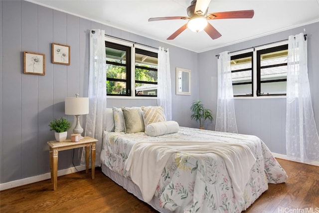 bedroom featuring hardwood / wood-style flooring, ceiling fan, and ornamental molding