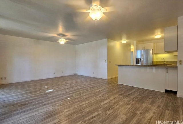 84-754 Ala Mahiku St Unit 52A, Waianae, HI 96792 - unfurnished living room featuring ceiling fan and dark wood-type flooring