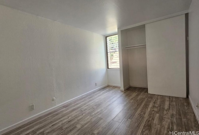 84-754 Ala Mahiku St Unit 52A, Waianae, HI 96792 - unfurnished bedroom featuring dark hardwood / wood-style flooring and a closet