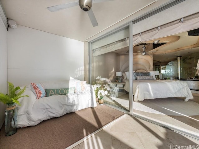 tiled bedroom featuring ceiling fan