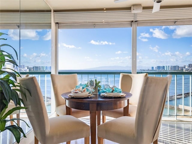 sunroom / solarium featuring a water view and plenty of natural light