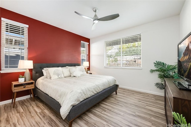 bedroom with hardwood / wood-style floors and ceiling fan