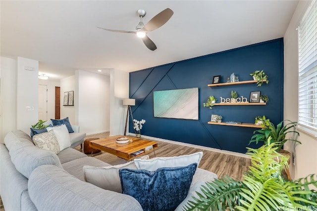 living room with hardwood / wood-style flooring and ceiling fan