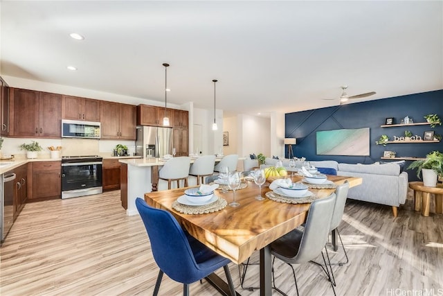 dining room featuring light hardwood / wood-style floors and ceiling fan