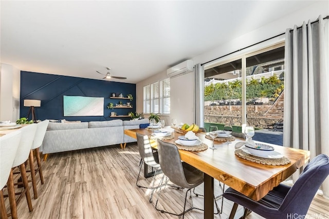 dining area with light hardwood / wood-style flooring, a wall mounted AC, and ceiling fan