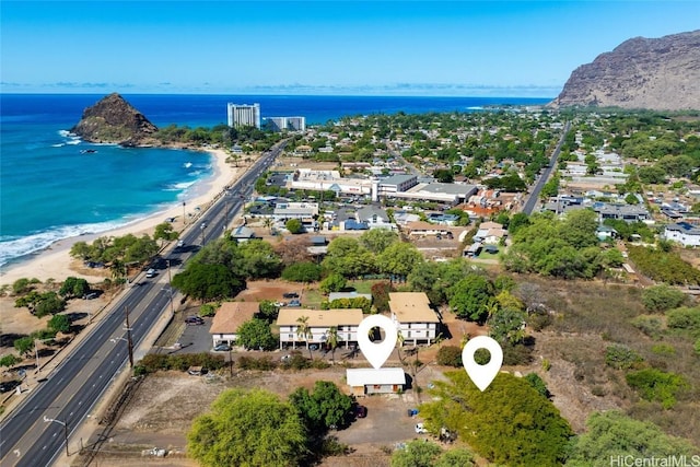 drone / aerial view featuring a water view and a beach view