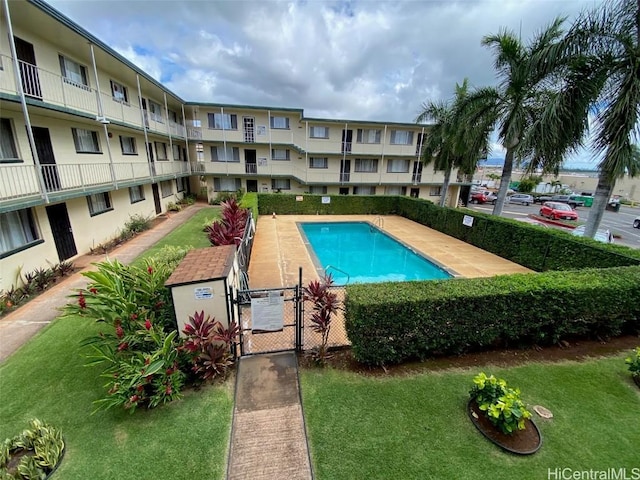 view of pool with a yard