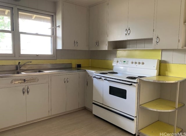 kitchen with white range with electric cooktop, white cabinets, sink, tasteful backsplash, and light hardwood / wood-style floors