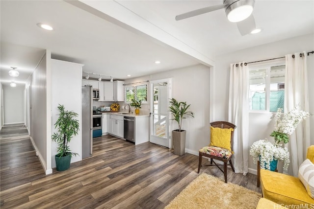 sitting room with beamed ceiling, dark hardwood / wood-style floors, ceiling fan, and sink