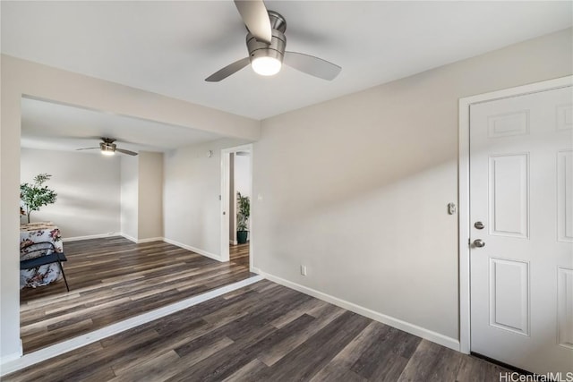 spare room with dark hardwood / wood-style floors and ceiling fan