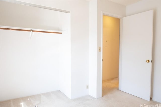 interior space with light carpet and a closet