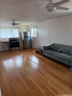 unfurnished living room with ceiling fan and wood-type flooring