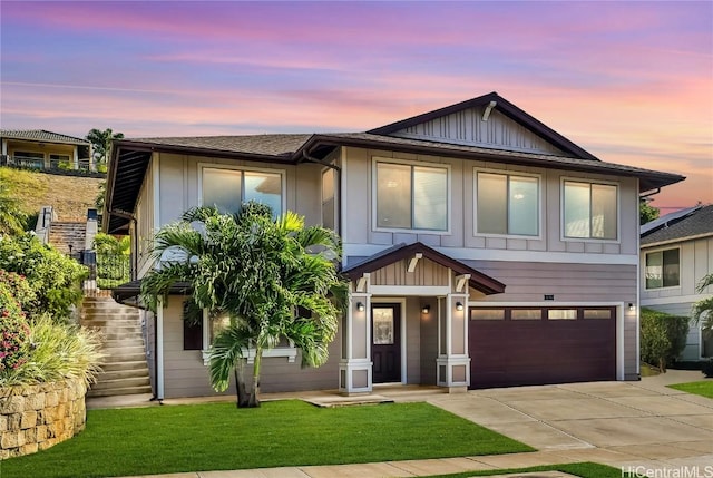 view of front of house featuring a lawn and a garage