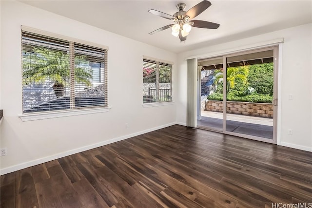 empty room with dark hardwood / wood-style flooring and ceiling fan