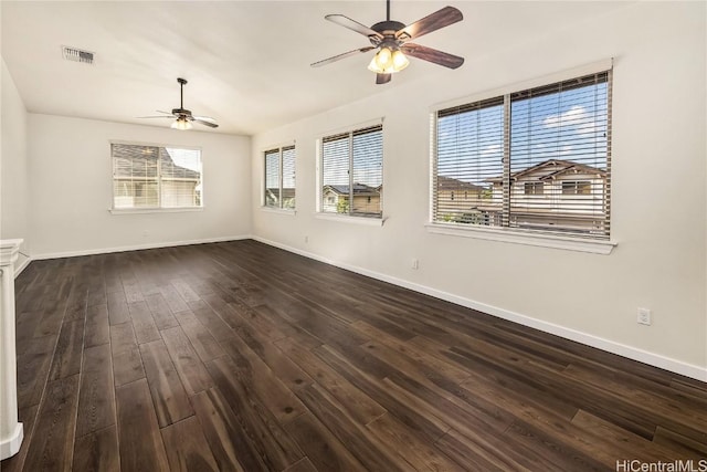 spare room featuring ceiling fan and dark wood-type flooring