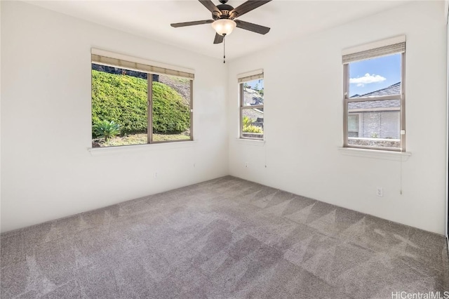 carpeted spare room with ceiling fan