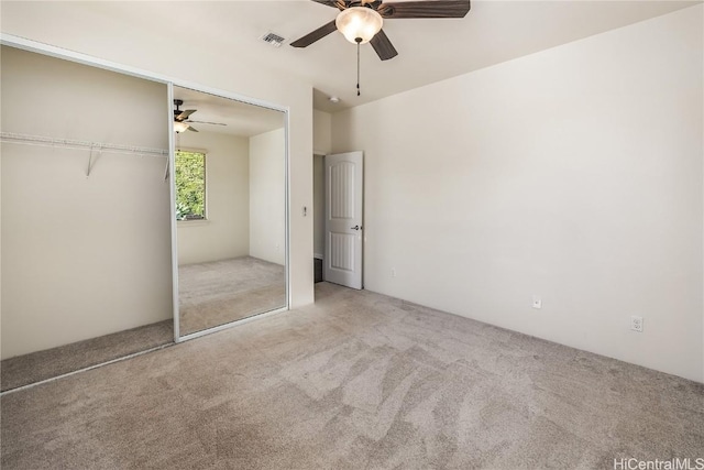 unfurnished bedroom featuring ceiling fan, carpet floors, and a closet