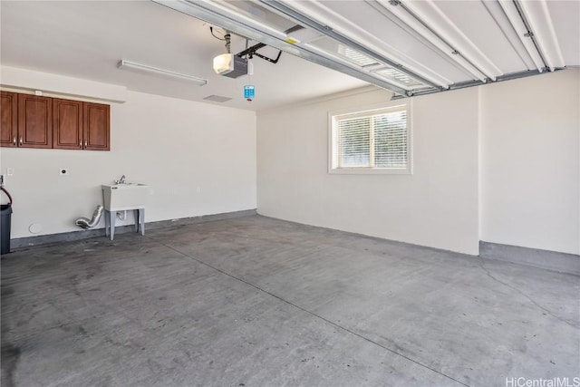 garage featuring sink and a garage door opener