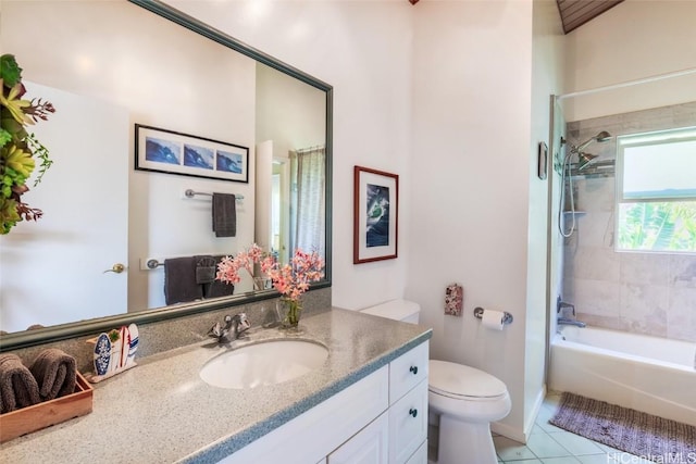 full bathroom with tiled shower / bath combo, tile patterned floors, vanity, and toilet