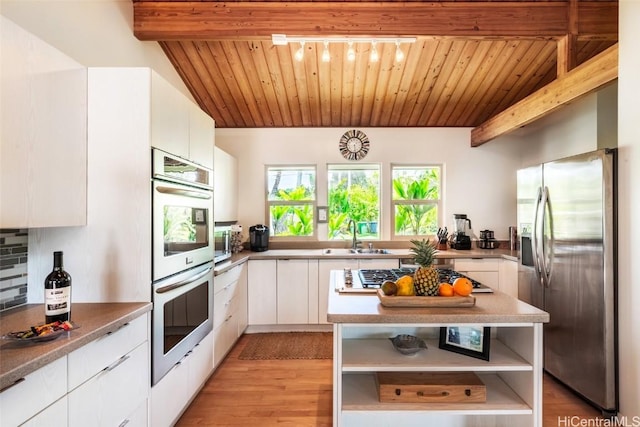 kitchen with appliances with stainless steel finishes, white cabinetry, sink, wooden ceiling, and light hardwood / wood-style flooring